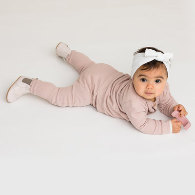 Baby on tummy wearing baby windsor boots in colour Stone