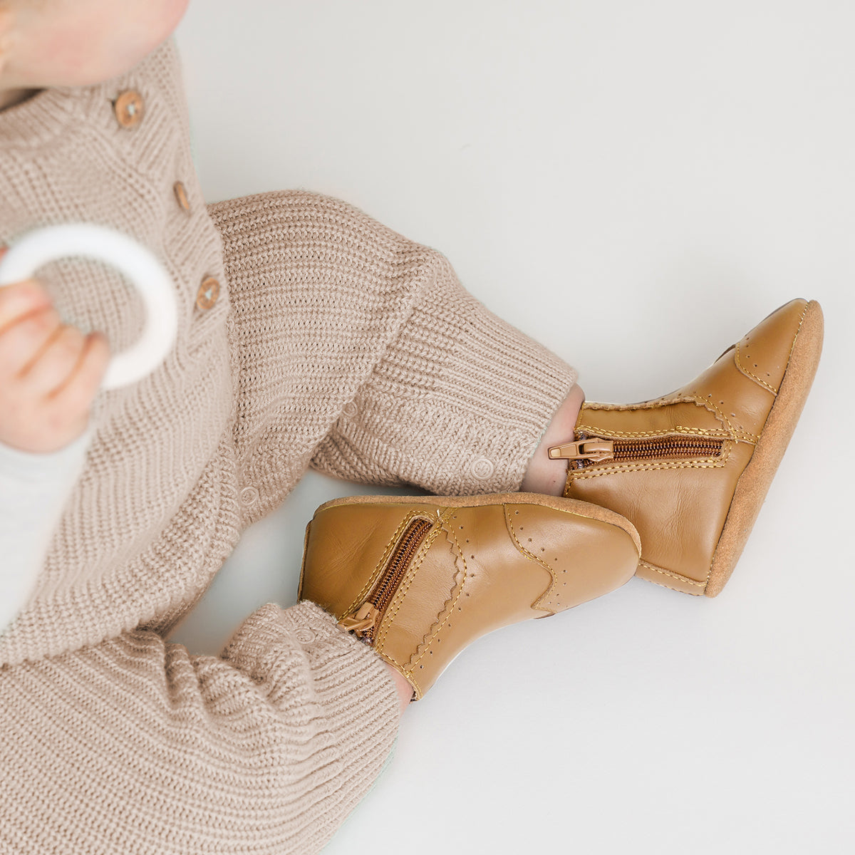 Baby wearing baby windsor boots in colour Tan, sitting on the floor