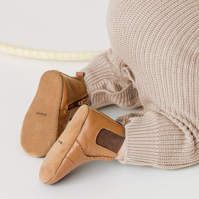 Baby wearing baby windsor boots in colour Tan and ribbed trousers