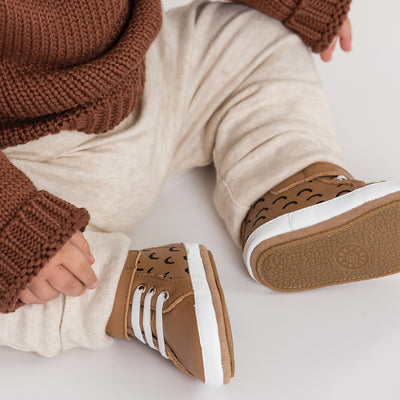 Baby wearing Hi top baby shoe in Chestnut colour