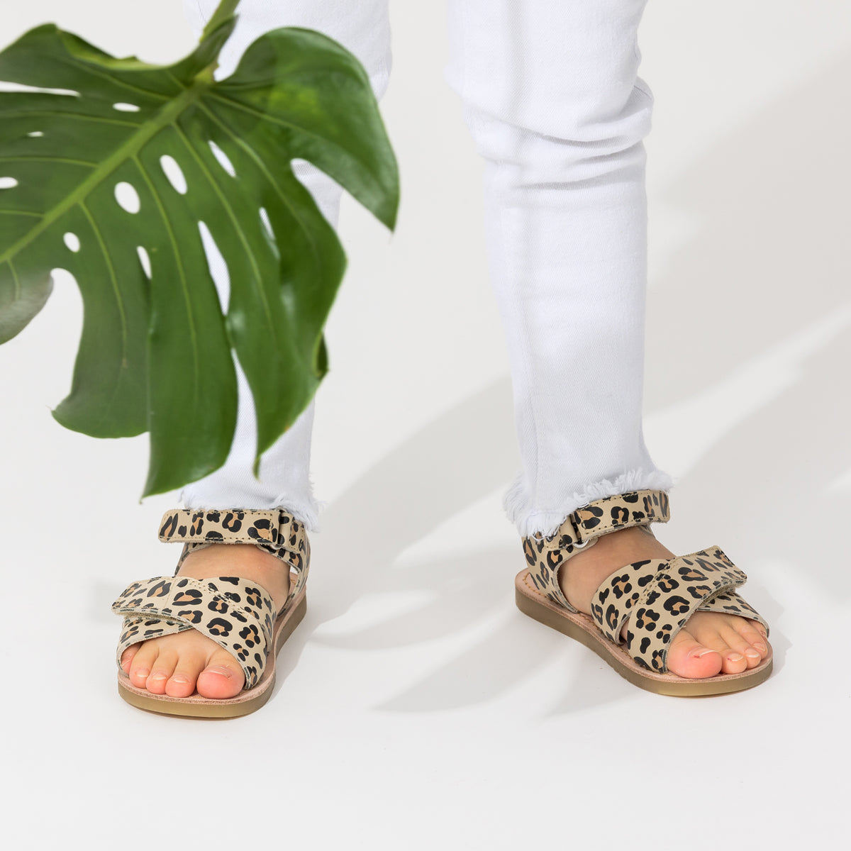Child wearing leopard print sandals