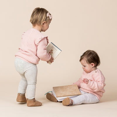 Two babies playing with each other wearing Baby Archie boots in colour Tan