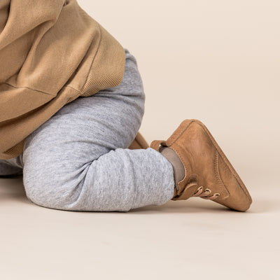 Baby crawling wearing Baby Archie boots in colour Tan