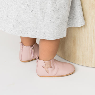 Toddler wearing baby boot in colour blush with lightning detail