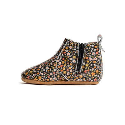 Side view of baby boots with flower design and zip detail