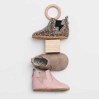 Three single baby boots in different colours 