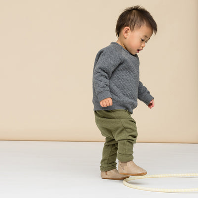 Toddler wearing baby electric boot in colour sand