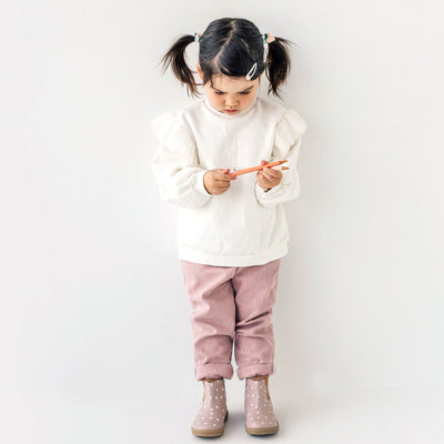 Child wearing Electric boot design in colour Primrose with white jersey