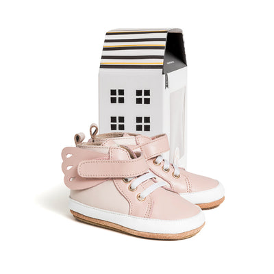 Butterfly hi-top shoe in pink next to cardboard box