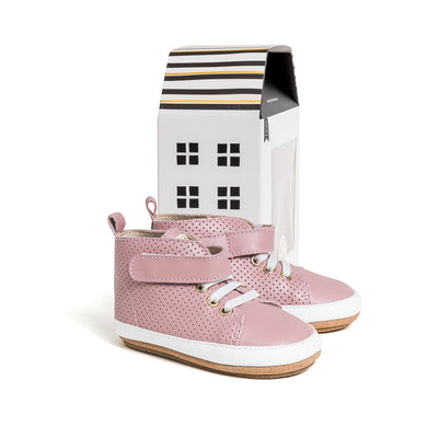 Pretty Brave Hi Top shoes in rose colour next to cardboard box