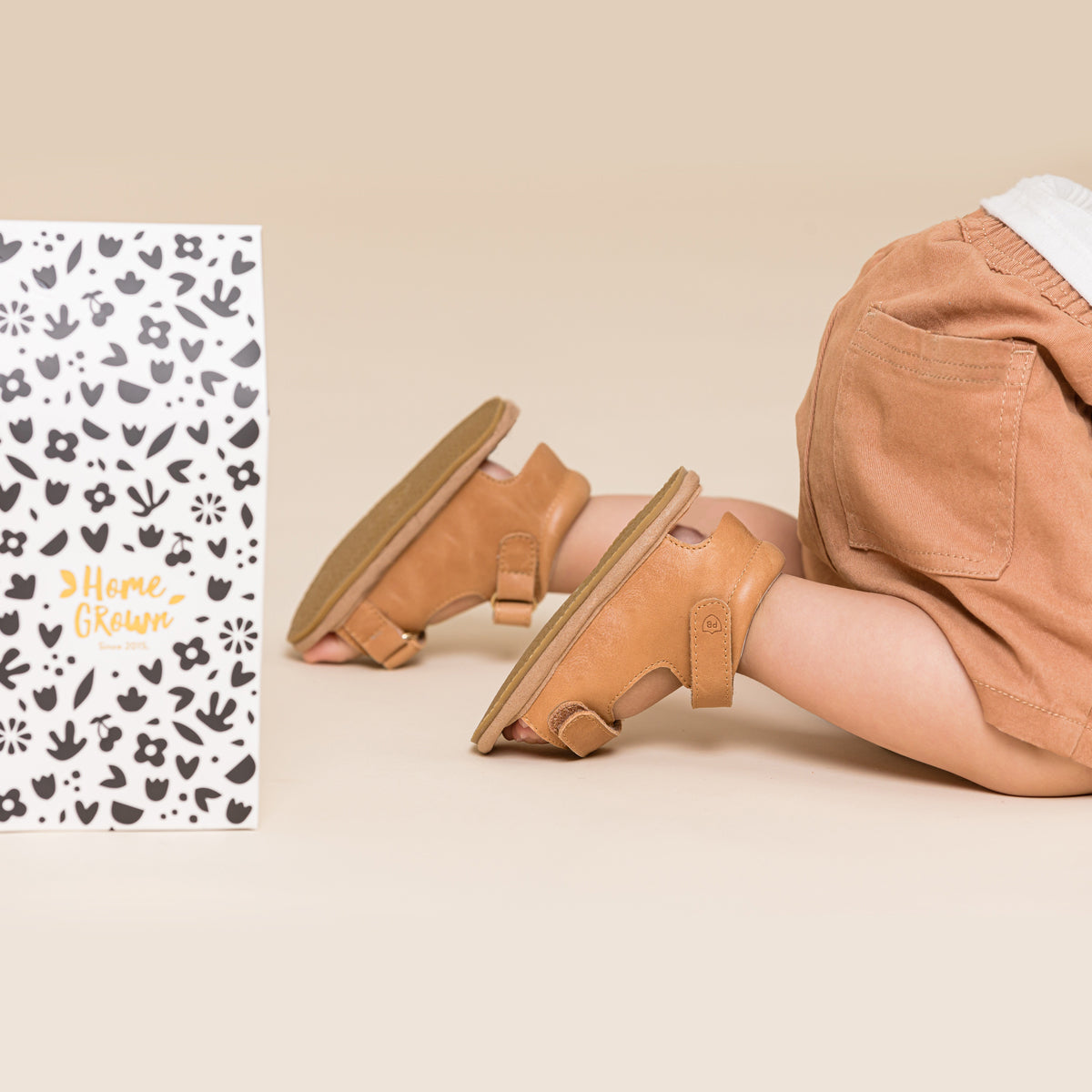 Baby crawling wearing baby sandals in sierra colour