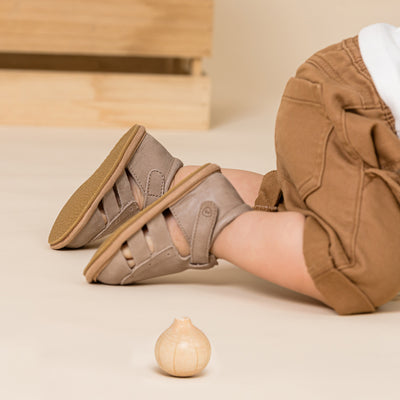 Baby crawling wearing Charlie sandal in Taupe colour