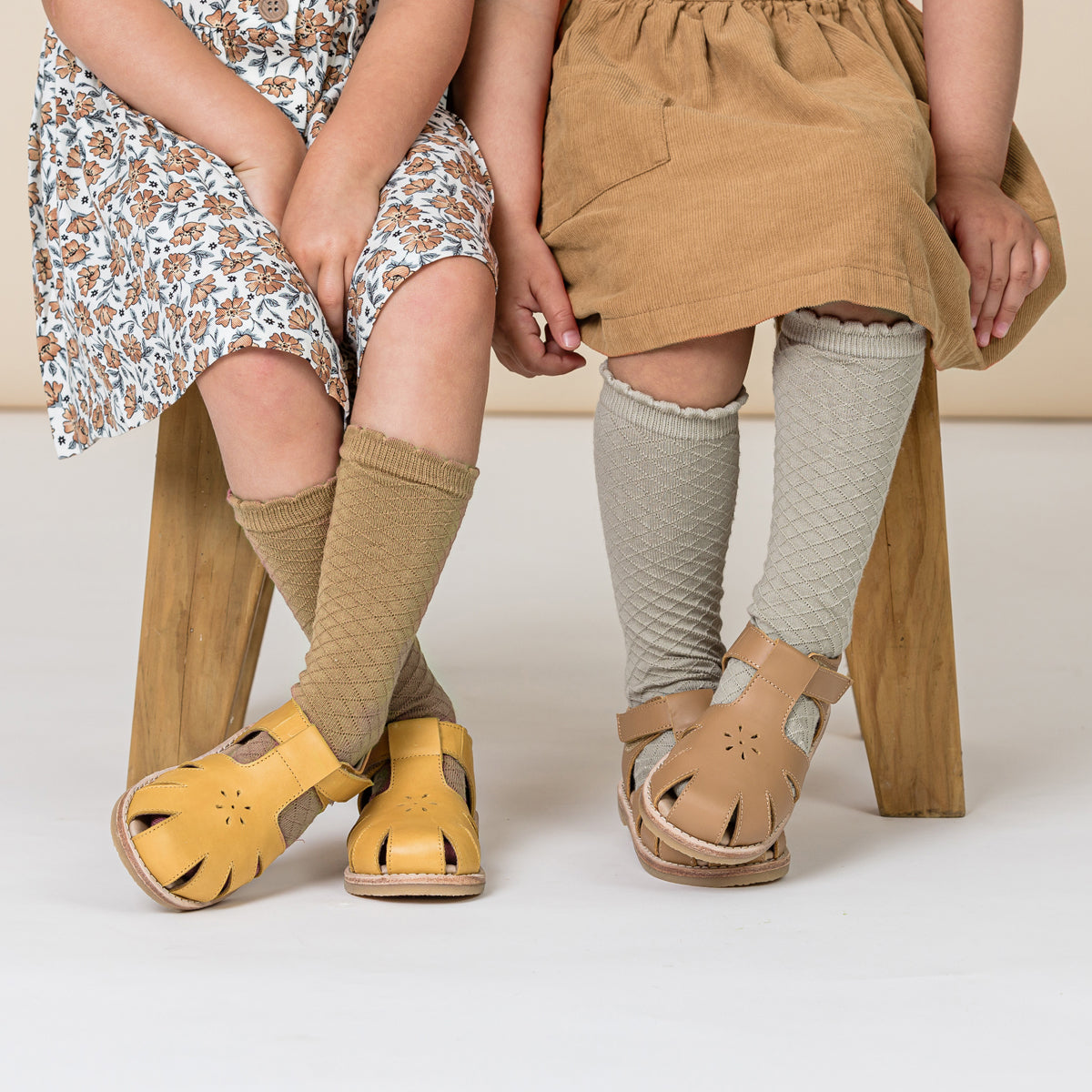 Toddlers wearing TBar sandals. 